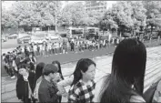  ??  ?? SUPPORTERS LINE up outside the courthouse. Being gay still carries a strong social stigma in China.