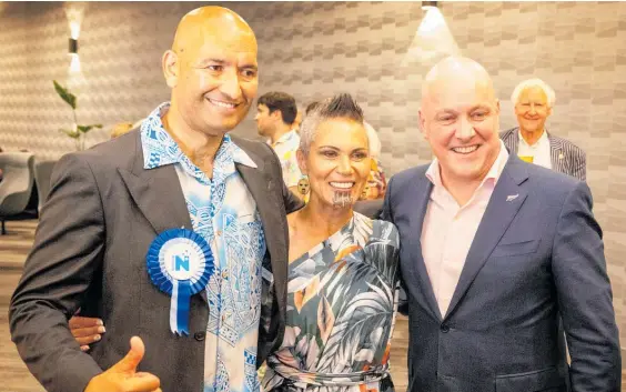  ?? Photo / Mike Scott ?? New Hamilton West MP Tama Potaka with wife Ariana and National leader Christophe­r Luxon after the result was announced.