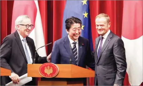  ?? KOJI SASAHARA/AFP ?? Japanese Prime Minister Shinzo Abe (centre), European Commission President Jean-Claude Juncker (left) and European Council President Donald Tusk (right) smile after a joint press conference at Abe’s official residence in Tokyo on Tuesday.