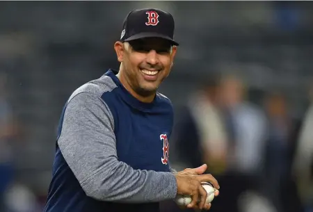 ?? CHRISTOPHE­R EVANS / HERALD STAFF FILE ?? ALWAYS CONFIDENT: Alex Cora gathers baseballs during batting practice prior to Game 4 of the American League Division Series against the New York Yankees in 2018.