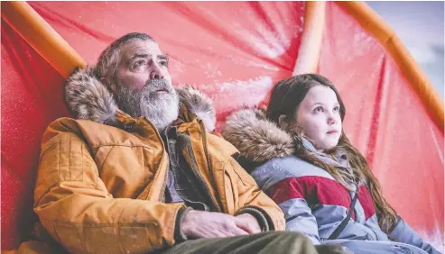  ?? PHOTOS: NETFLIX ?? The characters played by George Clooney and Caoilinn Springall are the last two people at a deserted observator­y in The Midnight Sky.