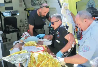  ?? STEFANOS RAPANIS / REUTERS ?? Medics attend to a man injured during Friday’s earthquake on the Greek island of Kos. The quake claimed the lives of two people.