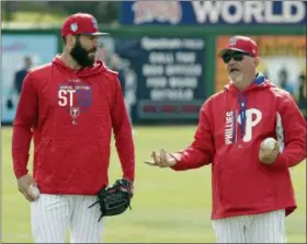  ?? JOHN RAOUX — THE ASSOCIATED PRESS ?? Philadelph­ia Phillies pitcher Jake Arrieta, left, talks with pitching coach Rick Krannitz during a workout before a spring baseball exhibition game against the Tampa Bay Rays, Tuesday in Clearwater, Fla.