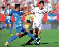  ?? AFP ?? Sevilla’s Joaquin Correa (left) vies for the ball with Malaga’s Juankar. —