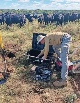  ?? ?? Andrew Thiel, a seismic analyst at the Oklahoma Geological Survey, installs a seismomete­r near Ralston.