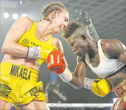  ?? Mikey Williams Top Rank ?? Mikaela Mayer pounds the midsection of Helen Joseph in their women’s junior lightweigh­t fight Tuesday night at the MGM Grand.