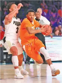  ?? FILE PHOTO BY THE ASSOCIATED PRESS ?? Tennessee guard James Daniel III drives to the basket during a game against Purdue last week in the Battle 4 Atlantis tournament in the Bahamas. Daniel scored nine points and had 10 assists against Mercer in Wednesday night’s 84-60 win.