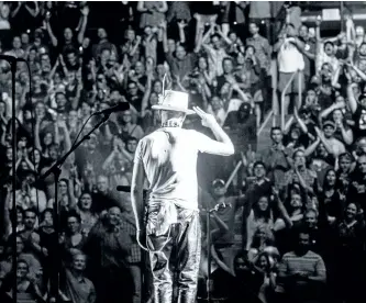  ?? HANDOUT ?? Gord Downie of The Tragically Hip salutes his fans during the band’s last show in Kingston, Ont., in a scene from the new documentar­y Long Time Running. The show and entire Man Machine Poem tour are the subject of the film.