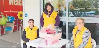  ??  ?? TARARUA and District Lions at work on Breast Cancer fundraiser raffle. From left, Christine, Sharon and Diane.