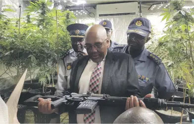  ?? Picture: Rorisang Kgosana ?? SHOCKED. Acting Minister of Police Aaron Motsoaledi examines one of the weapons found on a property in Centurion this week.