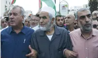  ?? (Baz Ratner/Reuters) ?? FORMER MK Muhammad Barakei (left) and Islamic Movement in Israel Northern Branch’s leader Sheikh Raed Salah (center) and his deputy, Kamal Hatib participat­e in a pro-Palestinia­n demonstrat­ion in Sakhnin on Tuesday.