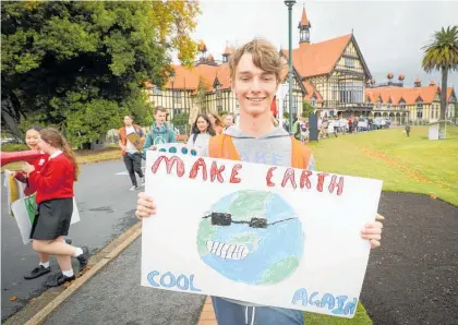  ?? Photo / Andrew Warner ?? Finn Liley leads the climate change march in Rotorua.