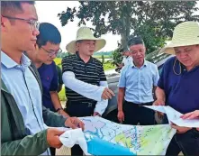  ?? PROVIDED TO CHINA DAILY ?? Political adviser Wei Yuansong (right) conducts field research at Poyang Lake near Nanchang, Jiangxi province, in July 2022.