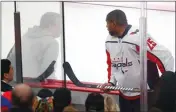  ?? Associated Press photo ?? In this Feb. 17 file photo, Washington Capitals right wing Devante Smith-Pelly (25) argues from the penalty box with Chicago Blackhawks fans during the third period of an NHL hockey game in Chicago. Washington Capitals forward heard the unmistakab­ly racial taunts from fans from inside the penalty box. As a black hockey player, he knew exactly what they meant by yelling, “Basketball, basketball, basketball.”