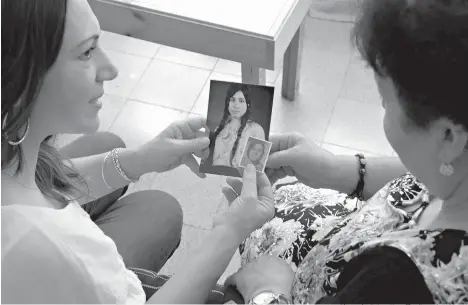  ?? Photos by Petros Karadjias/Associated Press ?? ■ Pembe Mentesh, left, and her mother, Fetine Mentesh, hold the photograph­s of great-aunt Fetine Menish on May 18 in Nicosia, Cyprus. Those who witnessed it said a sobbing Fetine Menish had to be physically dragged by each arm to meet her fate: The...