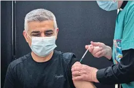  ?? Stefan Rousseau PA Images ?? SADIQ KHAN, the mayor of London, receives his first dose of the Pfizer COVID-19 vaccine at Mitcham Lane Baptist Church in South London on Friday.