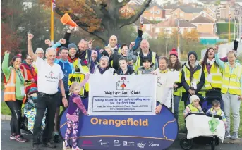  ??  ?? Niamh Lemon from Dundonald with park run volunteers, and (below) with dad Stephen