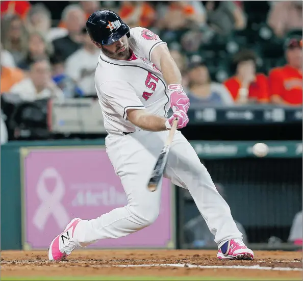  ?? — GETTY IMAGES ?? Houston Astros designated hitter Tyler White rips a ground-rule double Sunday against the Seattle Mariners in Houston.