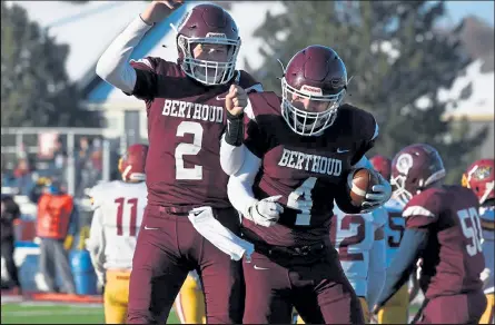  ?? RICHARD HARO / For the Reporter-herald ?? Berthoud’s Tristan Youngblood, left, and Logan Nichols celebrate a successful two-point conversion early in the game Tuesday against Brush. The Spartans went for a game-winning two-point attempt in double-overtime and were successful on that as well, giving them a 22-21 victory.