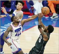  ?? MATT SLOCUM — THE ASSOCIATED PRESS ?? Brooklyn’s Kyrie Irving, right, tries to get a shot off against Shake Milton during the second half on Wednesday at the Wells Fargo Center.