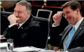  ?? AP ?? US Secretary of State Mike Pompeo, left, and Defence Secretary Mark Esper confer as they take their seats for their meeting with Australia’s Foreign Minister Marise Payne and Defence Minister Linda Reynolds at the New South Wales Parliament House in Sydney yesterday.