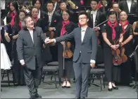  ?? GAO ER’QIANG / CHINA DAILY ?? Young musician Gong Tianpeng (right) and conductor Tang Muhai at the premiere of the choral symphony Revival for the opening of the 19th China Shanghai Internatio­nal Arts Festival.