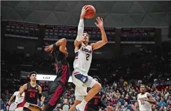  ?? JESSICA HILL/AP PHOTO ?? UConn’s James Bouknight (2) rises to the basket past Houston’s Caleb Mills (2) during the Huskies’ 77-71 win over the No. 21 Cougars on Thursday night in Storrs.