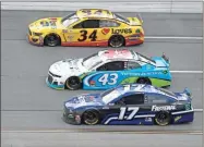  ?? AP-John Bazemore ?? Michael McDowell (34), Bubba Wallace (43) and Chris Buescher (17) ride side-by-side during a NASCAR Cup Series auto race at Talladega Superspeed­way.