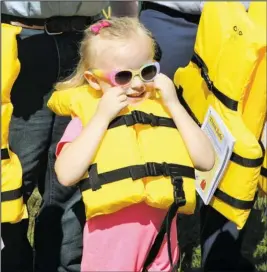  ?? The Sentinel-Record/Richard Rasmussen ?? SAFETY FIRST: Madison Moseley, 4, is all smiles while sporting a new life jacket Thursday while taking part in the kickoff ceremony for the new Life Jacket Loaner Station at Andrew Hulsey Fish Hatchery on Lake Hamilton. Officials are stressing boating safety this holiday and especially emphasizin­g the importance of life jackets.