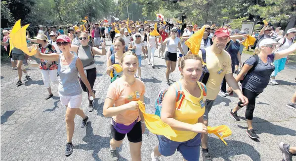  ?? JOHN SMIERCIAK/POST-TRIBUNE PHOTOS ?? Thousands of walkers approach the end of their journey on Sunday during the Polish Pilgrimage from Chicago to the Our Lady of Czestochow­a Shrine in Merrillvil­le, Indiana, on Aug. 8.