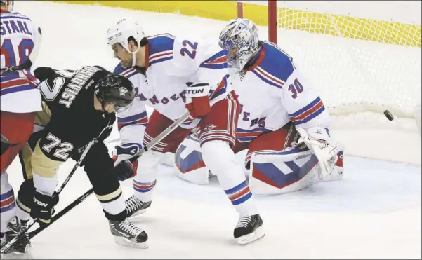  ?? Matt Freed/Post-Gazette ?? Patric Hornqvist scores the only Penguins goal of the game with a deflection in front of Rangers goaltender Henrik Lundqvist early in the first period Wednesday of Game 4 of a first-round Stanley Cup playoff series at Consol Energy Center.