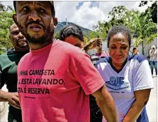  ?? CARL DE SOUZA / GETTY IMAGES LEO CORREA / ASSOCIATED PRESS ?? Left: Team employees wait in disbelief after Friday’s deadly fire at the soccer club Flamengo in Rio de Janeiro.Right: Grieving relatives arrive at the club’s training center on Friday. Many parents go out of their way to help their kids make it to Brazilian soccer academies in the hopes that the youths will land a big contract in Europe.