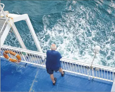  ?? JEREMY FRASER/CAPE BRETON POST ?? A passenger on board the MV Highlander­s looks overboard during an Aug. 7 crossing between North Sydney and Port aux Basques, N.L.