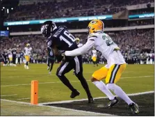  ?? MATT ROURKE - THE ASSOCIATED PRESS ?? Eagles receiver Quez Watkins dances into the end zone for a touchdown in front of Green Bay Packers cornerback Rasul Douglas just 13seconds before halftime Sunday night at Lincoln Financial Field.
