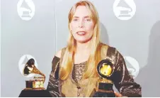  ?? — AFP file photo ?? In this file photo taken on Feb 27, 1996, Mitchell smiles as she holds two Grammy Awards at 38th Annual Grammy Awards in Los Angeles, winning Grammys for Best Pop Album for ‘Turbulent Indigo.’