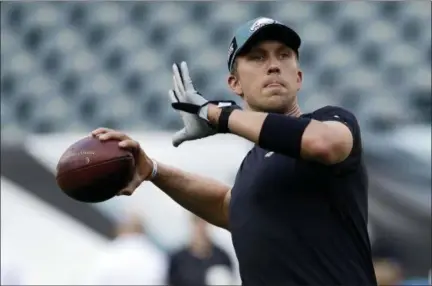  ?? MICHAEL PEREZ - THE ASSOCIATED PRESS ?? The Eagles’ Nick Foles warms up before the team’s Week 1 win over the Atlanta Falcons on Sept. 6 in Philadelph­ia.