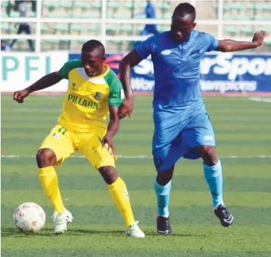  ??  ?? Amos Gyang (L) of Kano Pillars is challenged by an Enyimba player during their league clash at Sani Abacha Stadium last season