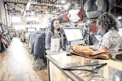  ?? AARON ONTIVEROZ The Denver POST/TNS ?? Louisa Kelly purchases used ski touring gear as Isabel Gourley rings her up at Feral mountain gear. Many independen­t outdoor retailers saw sales declines in 2023, but Feral is thriving thanks to its focus on buying and selling used gear.