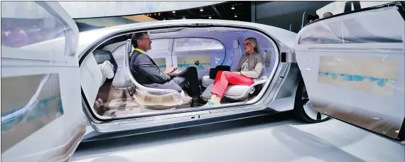  ?? — THE ASSOCIATED PRESS FILES ?? Attendees sit in the self-driving Mercedes-Benz F 015 concept car earlier this month in Las Vegas.