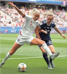  ?? RICHARD HEATHCOTE/GETTY IMAGES ?? Steph Houghton, left, battles Scotland’s Erin Cuthbert for the ball during Sunday’s Group D match won by England 2-1.