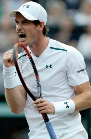  ?? (Photo by Alastair Grant, AP) ?? Andy Murray celebrates winning a point against Fabio Fognini during their Men’s Singles Match on day five at Wimbledon in London Friday.