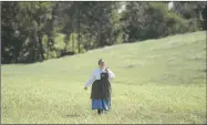  ?? NWA Democrat-Gazette photograph­s by Charlie Kaijo ?? Keiana McCoy of Prairie Grove, in 19th century attire, walked across a field near the Missouri border Friday.