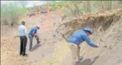  ?? PTI ?? Members of the GSI and the INTACH inspect the Ramgarh Crater in Baran district on Friday.