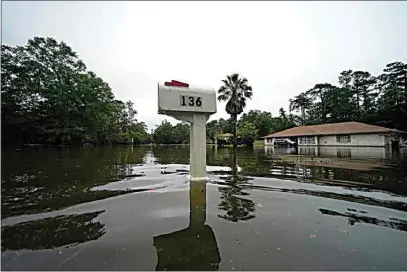  ?? GERALD HERBERT / AP ?? A flooded neighborho­od is seen after Tropical Storm Claudette passed through in Slidell, La., Saturday.