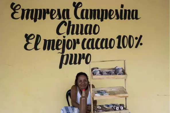  ?? AFP/VNA Photo ?? HAND MADE: Vicenta Gamez, 66, sits at a stall selling chocolate products made by hand with the harvest of agricultur­al workers in the town of Chuao, Venezuela.