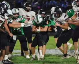  ?? PILOT PHOTO/BEV HARAMIA ?? Bremen’s Cody Czarnecki tries to get through the grasp of the Glenn defense during a game earlier this season. The Lions hit the road to Manchester for this week’s sectional game.