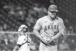  ?? Karen Warren / Staff photograph­er ?? The Angels’ Mike Trout grimaces in pain after getting hit by a pitch from Cristian Javier during the fourth inning.