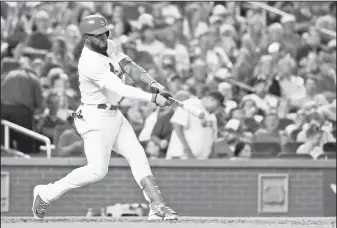  ?? AP/JEFF ROBERSON ?? St. Louis Cardinals’ Marcell Ozuna hits a two-run home run Monday against the San Diego Padres in St. Louis.