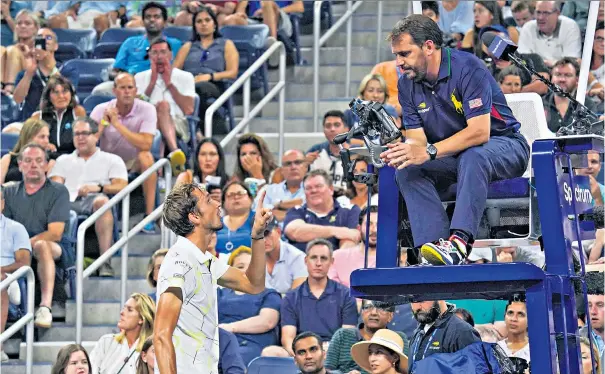  ??  ?? Fighting talk: Daniil Medvedev has a frank exchange of views with umpire Damien Dumusois during his tense win over Feliciano Lopez in the Louis Armstrong Stadium, where he also gave spectators a one-fingered salute