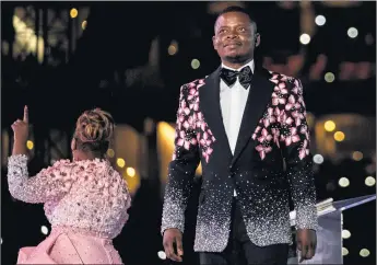  ?? WIKUS DE WET/GETTY-AFP ?? Pastor Shepherd Bushiri, with his wife, Mary Bushiri, is wanted in South Africa on fraud and moneylaund­ering charges.